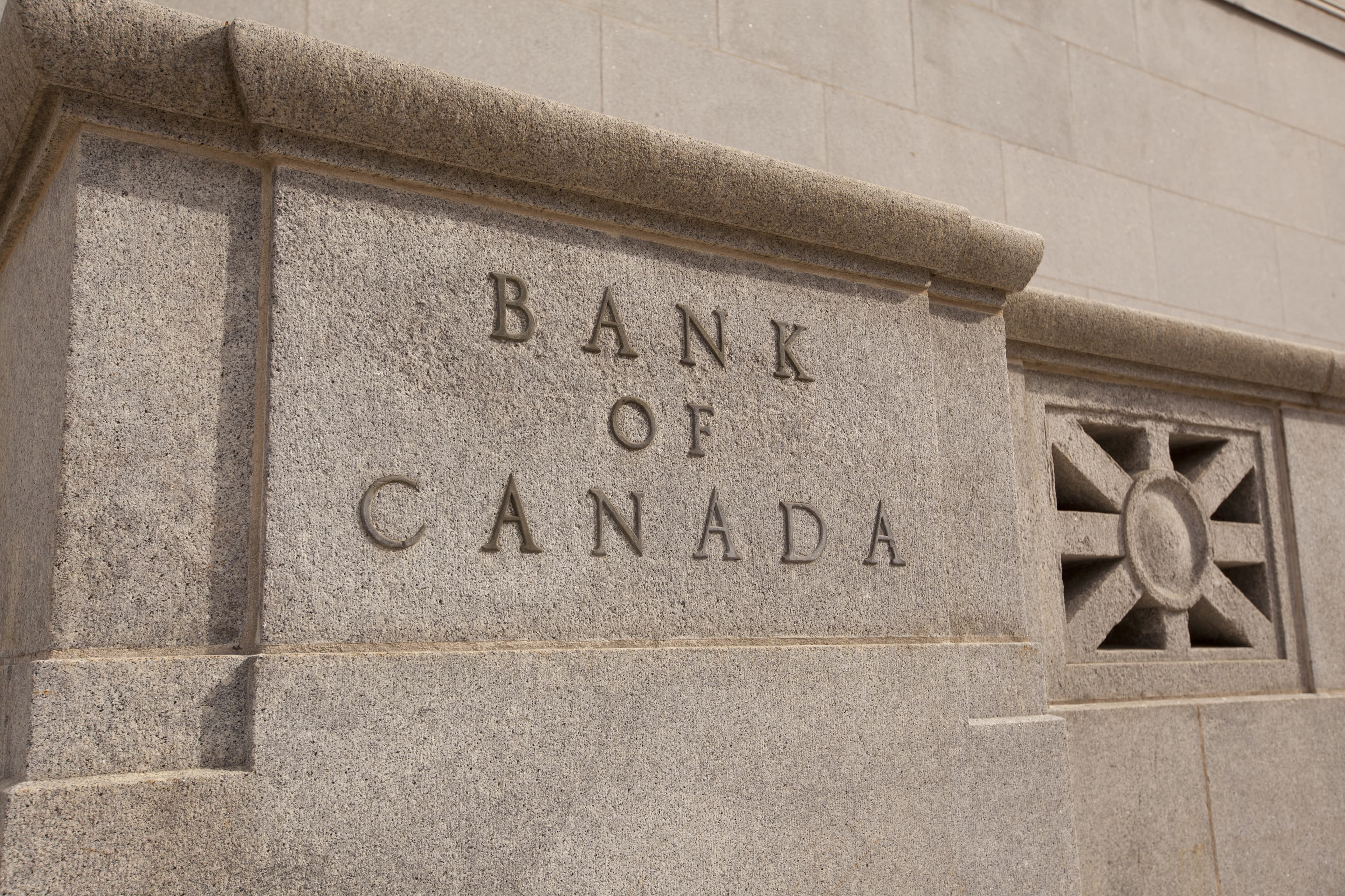 The stone facade of the Bank of Canada with engraved lettering.