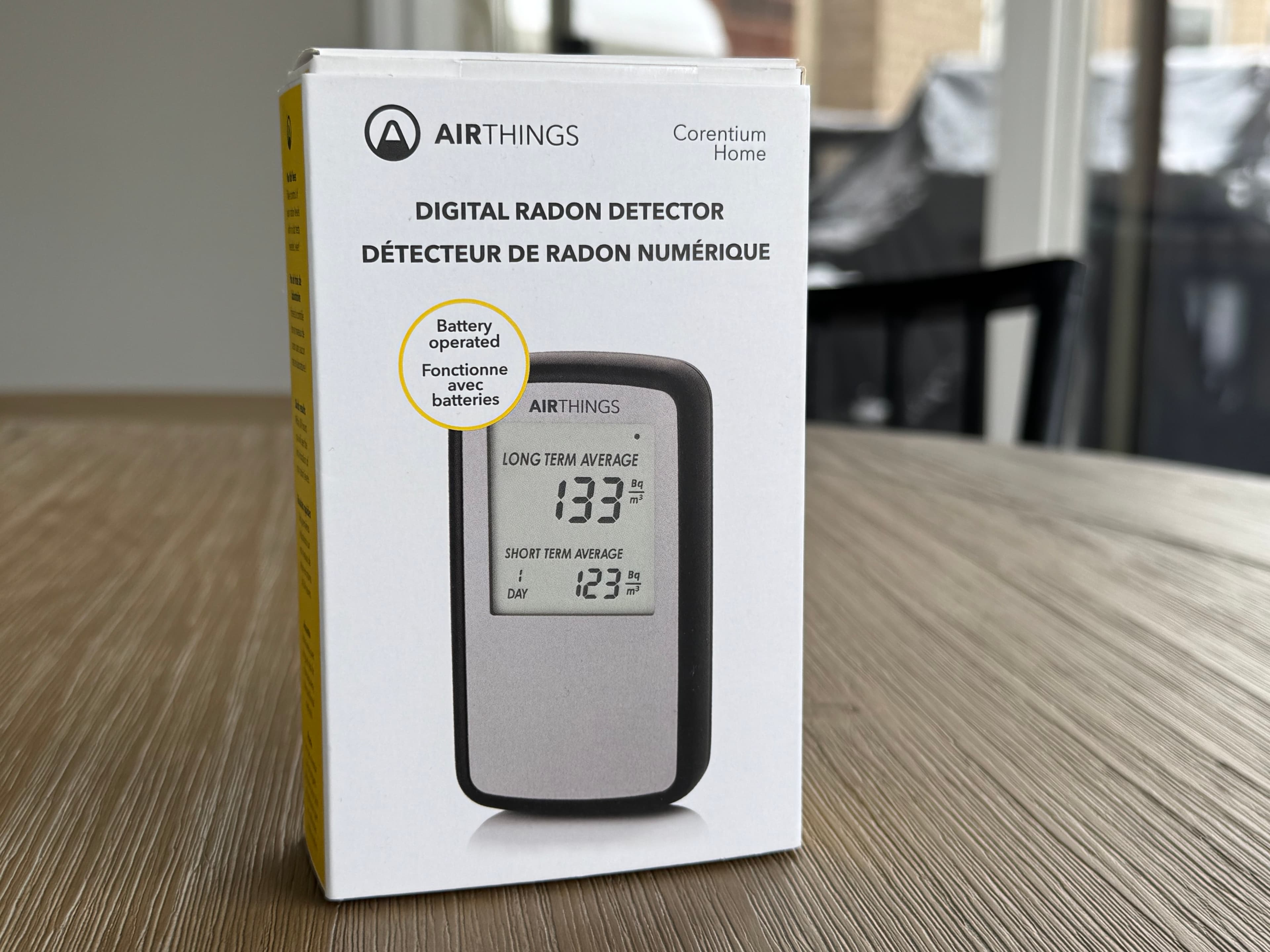 Airthings Corentium Home radon detector packaging on a table.